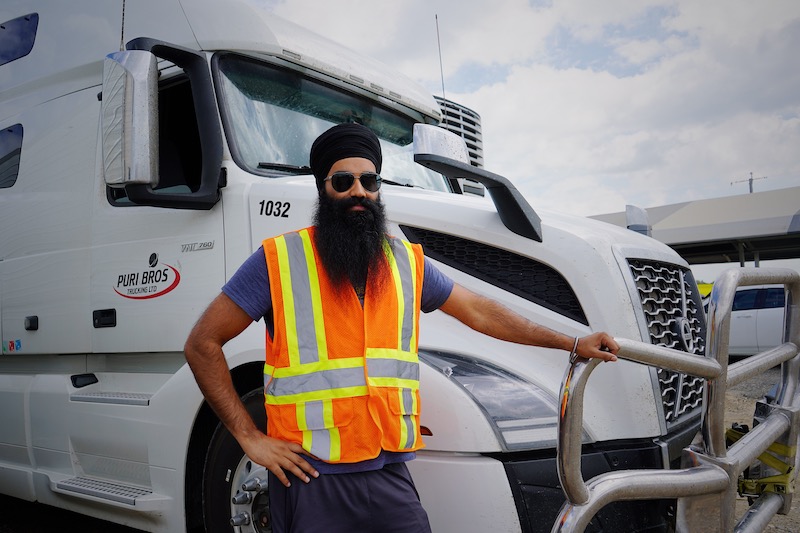 Man driving truck with sunglasses, courtesy World Sikh Organization of Canada @ Pexels #14797994